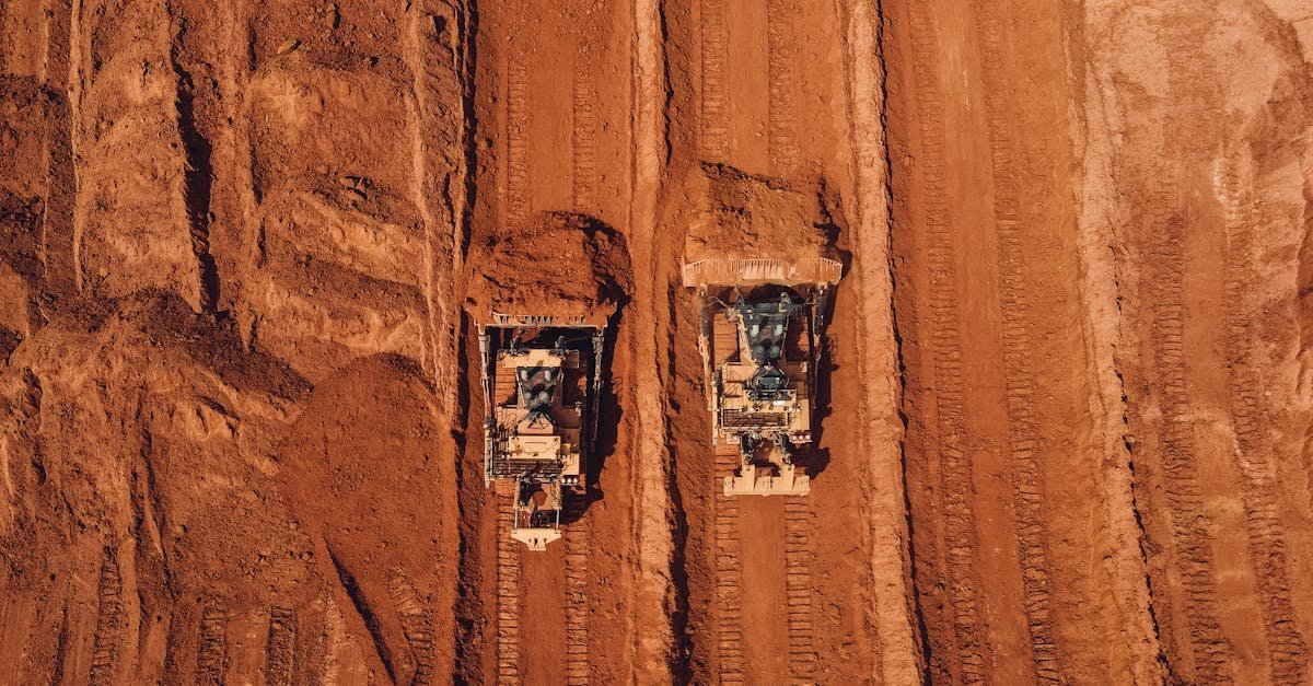 Aerial shot of two tractors excavating red earth, showcasing construction and mining machinery in Brazil.